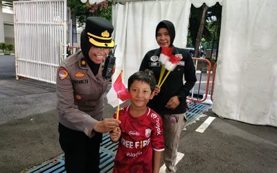 Polwan Polresta Surakarta Bagikan Bendera Merah Putih di Stadion Manahan